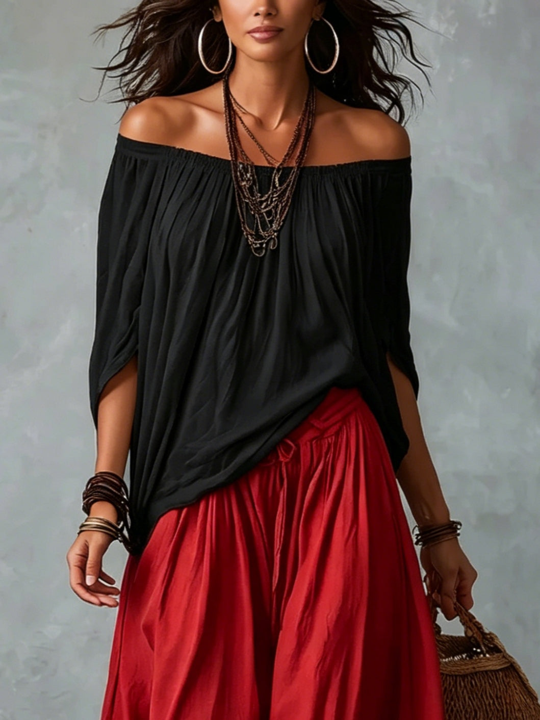 Top noir épaules dénudées et pantalon rouge ample coupe ballon